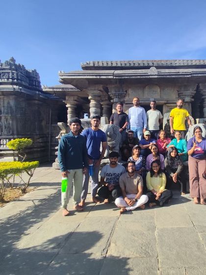 Our trekking group posing in front of a beautiful stone temple, combining the spiritual and adventurous aspects of the journey.
