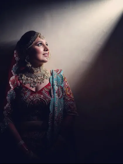 A dramatic, beautifully lit portrait of a royal bride. The heavy polki set stands out, showcasing its intricate design and regal feel.
