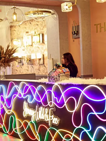 The reception desk for the store launch, featuring a custom neon sign with the brand's tagline "Young, Wild & Free". This element immediately communicated the fun and energetic vibe of the event.