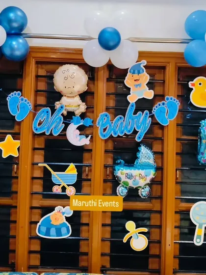 An 'Oh Baby' wall decoration for a baby boy, with various themed cutouts like a baby carriage, rattle, and duck.