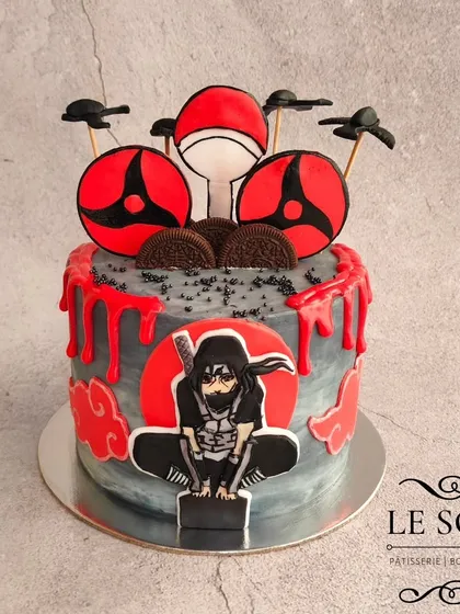 For all the anime fans, here's an Itachi Uchiha cake that was so much fun to design. This Milk & Cookies cake features a 2D fondant Itachi, his Sharingan, and a dramatic red and grey buttercream finish with a blood-drip effect.