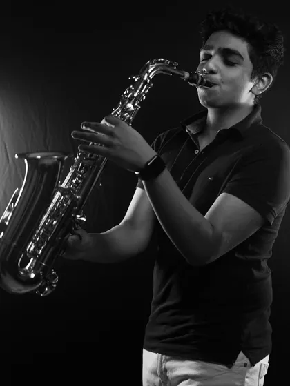 Meet Enrico, on saxophone and rhythm guitar. His smooth sax lines add a touch of soul and sophistication to our sound, perfect for setting the mood during a cocktail hour or adding flair to a dance number.