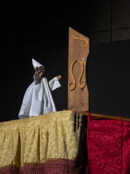 The iconic Pulcinella puppet, with his black mask and white costume, takes center stage in this musical performance from Italy.