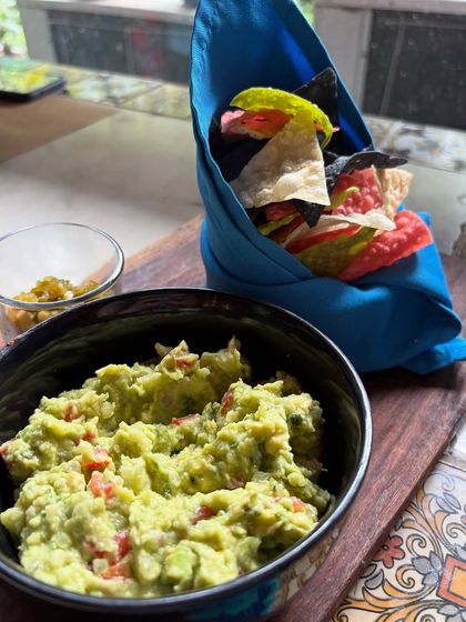 You can't go to a Tex Mex spot and not get the guacamole. This shot highlights the freshness of the ingredients and the colorful presentation of the house made chips, key details for any food lover.
