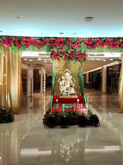 A wider view of the Ganesha entrance setup, flanked by shimmering gold curtains. This shows how the decor element is integrated into the larger space to create a grand welcome.