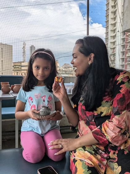 A candid moment between a mother and daughter admiring the small piece she has just painted. It’s these little moments of pride and accomplishment that make it all worthwhile.