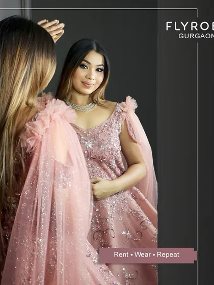 Rental fashion and savings go hand in hand. This model looks stunning in a pastel pink gown, proving you can look glamorous on a budget.