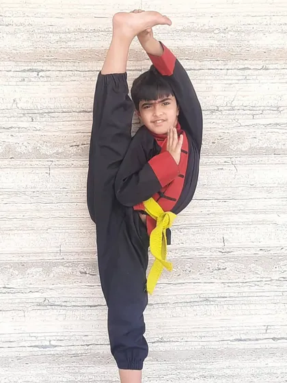 This is what dedication looks like. After one year of consistent training in my Shaolin Kung Fu program, this young student is demonstrating a perfect standing split, showcasing incredible hamstring flexibility and balance.