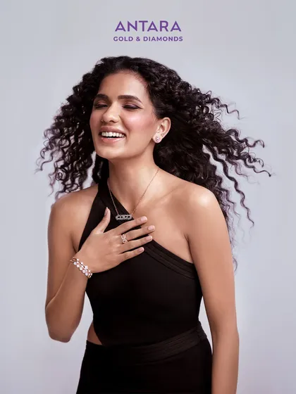 A diamond that tells her: "You did it. You deserve this." This image captures a moment of pure self-appreciation, adorned with a modern diamond necklace, bracelet, and ring from the collection.