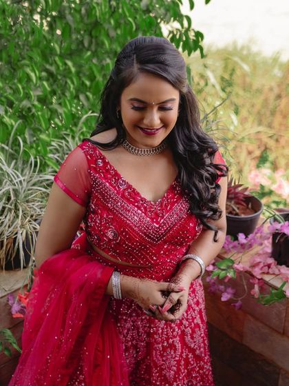Flawless makeup is every bride's dream. This bride looks stunning in her red engagement outfit, with makeup that enhances her natural glow.