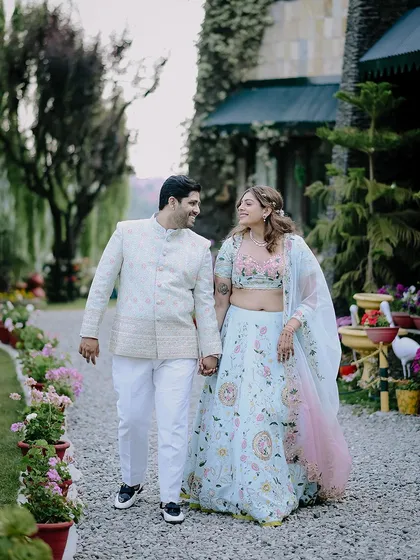 A happy, candid shot of the couple walking hand-in-hand during their engagement celebration in Nainital. Their smiles show the pure joy of the moment.