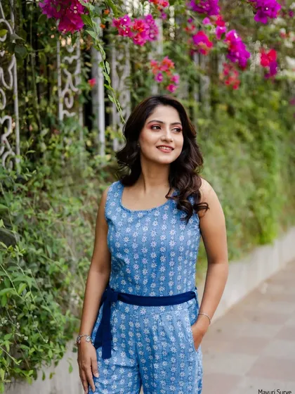 A lovely outdoor portrait with vibrant bougainvillea flowers in the background. This shot adds a pop of color and a fresh, natural feel to the actress's portfolio.