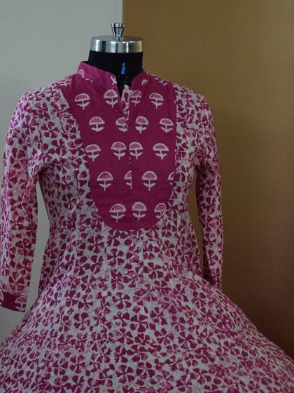 A closer look at the yoke of the pink block-printed Anarkali, showing the intricate pattern and the mandarin collar detail.