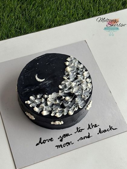 "Love you to the moon and back." This aesthetic, hand-painted buttercream cake depicts a dreamy night sky. It was one of two twin cakes for sisters.