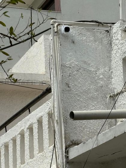 An outdoor camera installed with wiring neatly concealed within a PVC pipe. This protects the cables from weather damage and prevents easy tampering, ensuring long-term reliability.