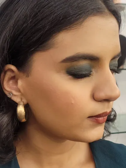 A three-quarter view that provides a clear look at the eyeshadow blending and contouring for this evening makeup style.