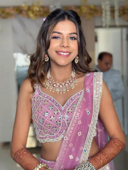 A bright and smiling portrait. The half-up style with soft waves is a universally flattering choice for bridesmaids or sisters of the bride.