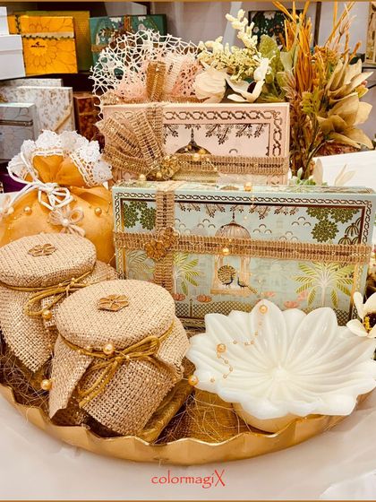 A beautifully styled shot of our golden-themed round tray wedding hamper, showcasing its intricate details and premium contents. This is a perfect centerpiece for any wedding celebration's gift table.