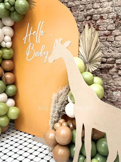 A close-up of the giraffe cutout against the orange arched backdrop. The 'Hello, Baby' text adds a sweet and simple message.