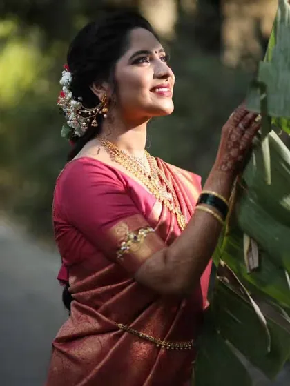 A candid, sun-kissed shot of the bride-to-be, her natural beauty enhanced by soft, glowing makeup.