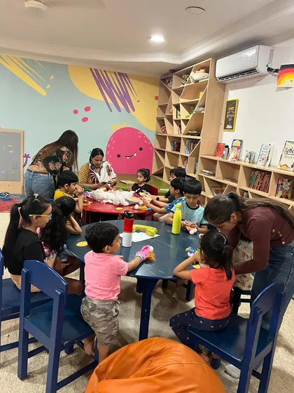 Our library is filled with unlimited drama and fun. Here, children are proudly showing off the puppets they've made, ready to put on a show.