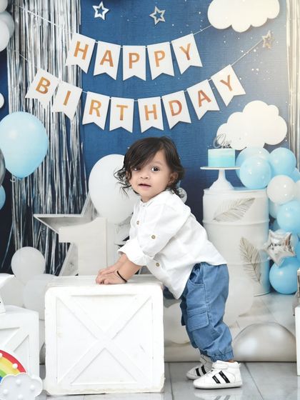 Exploring his birthday setup. I love capturing these moments of movement and curiosity during a first birthday shoot.