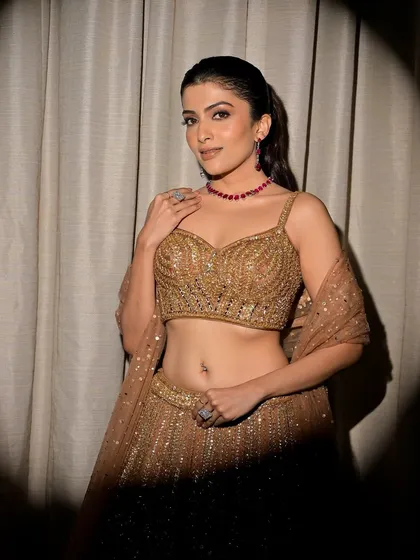 This spotlight shot highlights the drama of the smokey eye and the beautiful silhouette of her outfit. It's a perfect look for a sangeet or cocktail party.