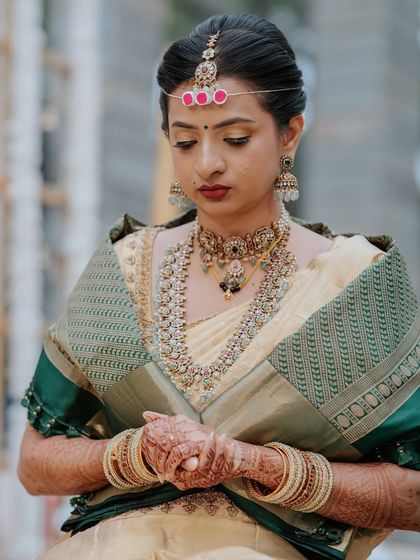 A portrait showing the details of her traditional headpiece and jewellery.