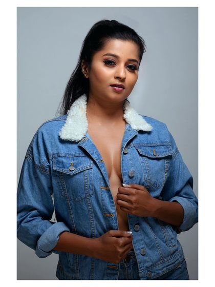 A bold and stylish portrait in a denim jacket. The pose is confident and the look is modern and edgy.