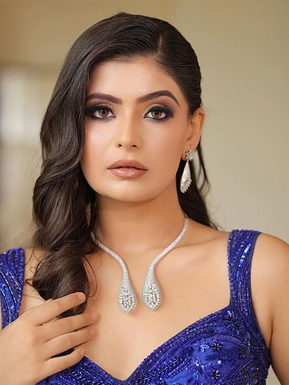 A close-up of the "Blue Lagoon" look. This shot highlights the intense smokey eye makeup and the flawless, glowing base that makes the whole look pop.