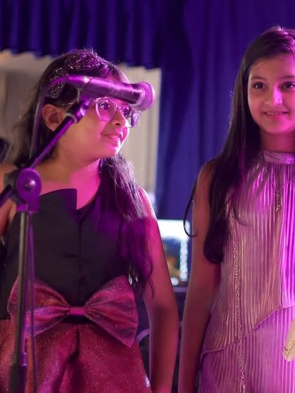 A candid moment of teamwork and fun between our young performers on stage. Learning music together builds friendships and shared memories.