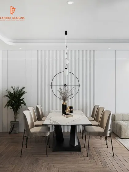 The dining space is defined by its simplicity. A statement pendant light hangs over a marble-top table, surrounded by comfortable, neutral-toned chairs.