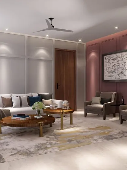 This angle shows an accent wall in a deep mauve, adding warmth and character to the living space. The neutral sofa and armchairs are arranged to encourage conversation and relaxation.