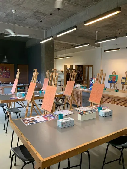 The calm before the creative storm. Our studio is prepared for an adult painting workshop, with easels and prepped canvases awaiting our artists. We provide a professional, well-equipped, and inspiring space for you to relax and create.