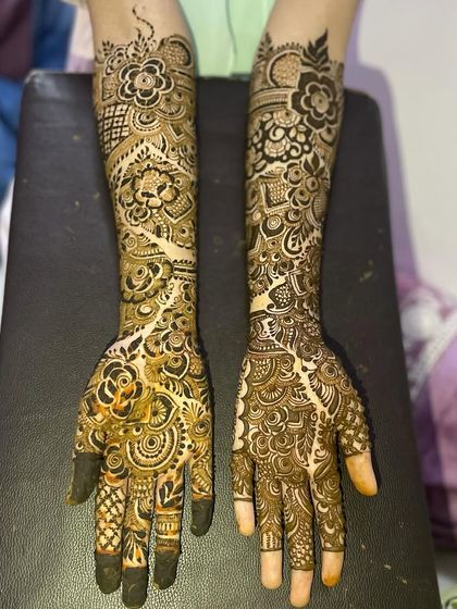 This design features a flowing vine pattern that creates a beautiful negative space element down the center of the arm. It's paired with dense, traditional work on the other arm for a unique asymmetrical look.