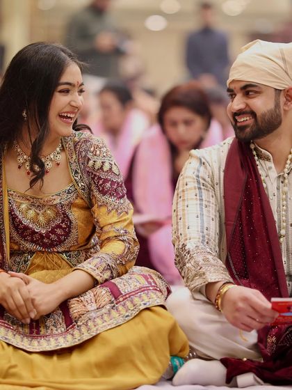 Candid moments are the best. For our Mata Ki Chowki, his simple striped kurta with a rich velvet shawl perfectly balanced the heavy embroidery of my yellow Anarkali, creating a beautiful contrast.
