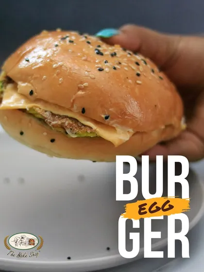 Our Egg Burger, or desi Bun Omelette, is a hearty and healthy snack. It features an egg patty in a soft, freshly baked bun.
