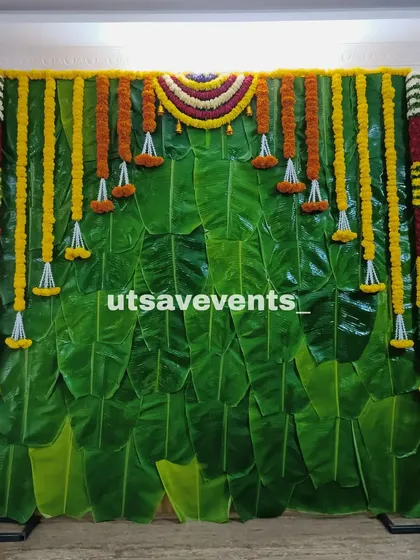A simple and elegant backdrop made entirely of banana leaves and marigold flower garlands. This is a perfect choice for an eco-friendly and traditional South Indian event.