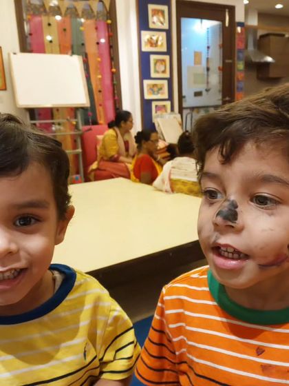 Looks like these two-and-a-half-year-old twins had a lot of fun with face paint during their art class! Messy play is a huge part of the creative process.