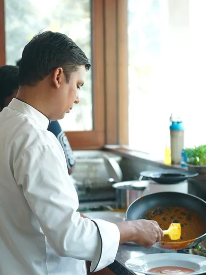 Our chef plating a dish with precision and care. We bring the restaurant experience to your home, ensuring every dish is served with professional flair for your private events.