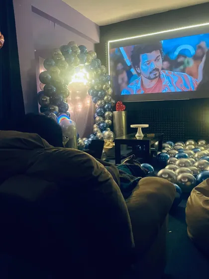 A guest's-eye view from the recliner, showing the birthday decorations and a movie on screen. It’s the best seat in the house.