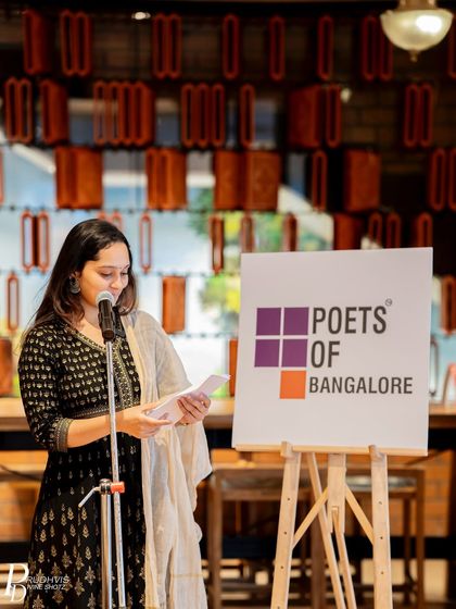 A poet reads her work, contributing to the "Wheel of Life" theme. The event was a vibrant celebration of literature and storytelling.