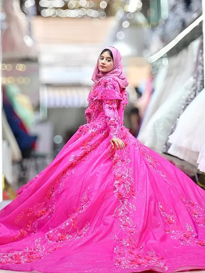 For the bride who loves bold color, I created this magnificent fuchsia pink ball gown. The entire gown is a canvas of intricate floral embroidery and 3D appliqués, making it a true masterpiece of wearable art.
