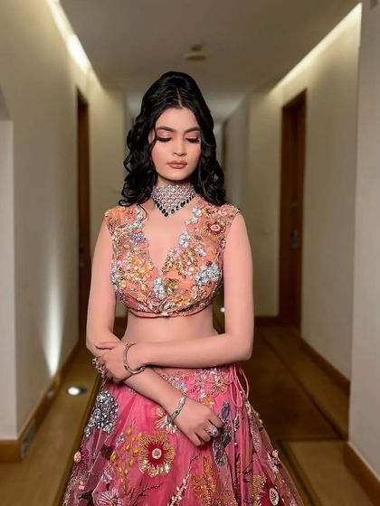 A serene, eyes-closed shot that highlights the beautiful details of the outfit.