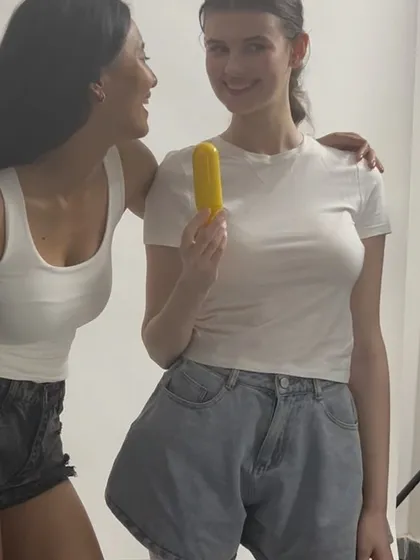 A candid and happy moment between two models on set during a skincare shoot.