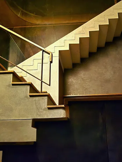 Architecture is a play of layers, light, and form. This staircase is more than a transition; it is a sculptural composition where the raw texture of concrete and the sharp geometry of the steps create a silent, powerful dialogue.