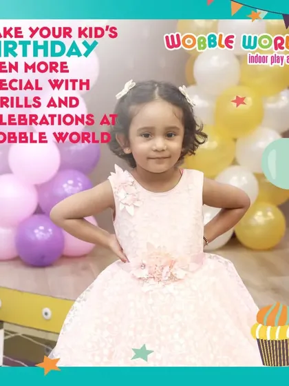 A young birthday girl posing confidently in her party dress, surrounded by festive balloons. We make every child feel like the star of the show.