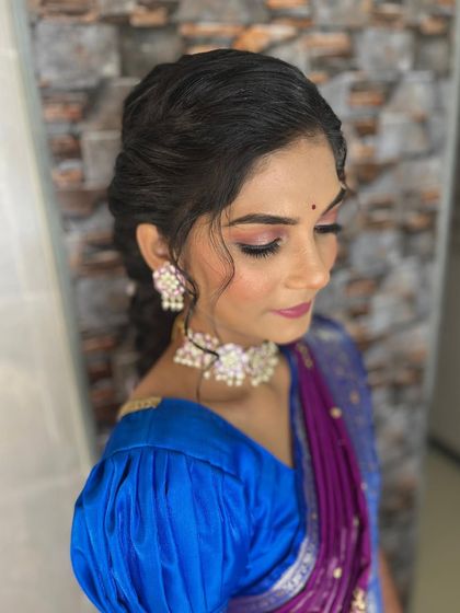 A side view of the floral braid, showing the soft, face-framing pieces at the front. This ensures the style is flattering from the front while showcasing the intricate braid at the back.