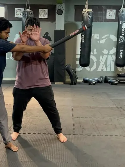 This is a stick defense drill. The key is to move off the line of attack and block with the fleshy part of your forearm, not the bone. From here, you control the weapon and counter.