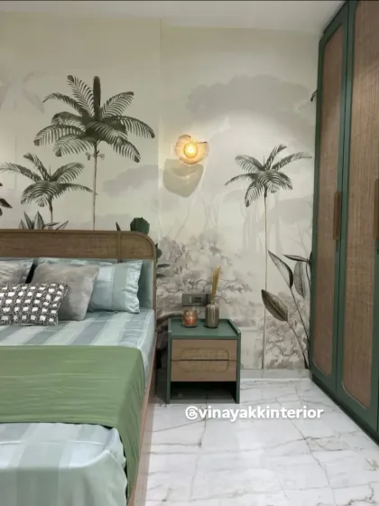 I love bringing nature-inspired elements into a bedroom. This design features a calming palm tree mural, a rattan headboard, and sage green accents in the bedding and nightstand. The result is a tranquil, resort-like retreat.
